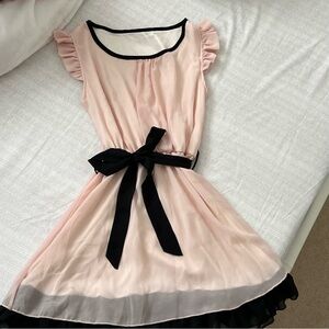 Pink and black babydoll dress with a bow
